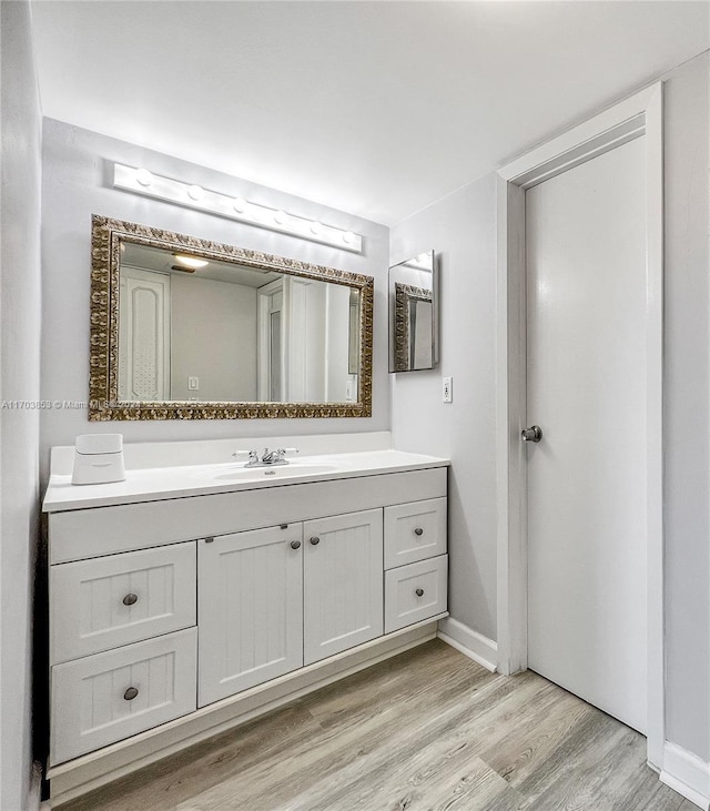 bathroom featuring hardwood / wood-style floors and vanity