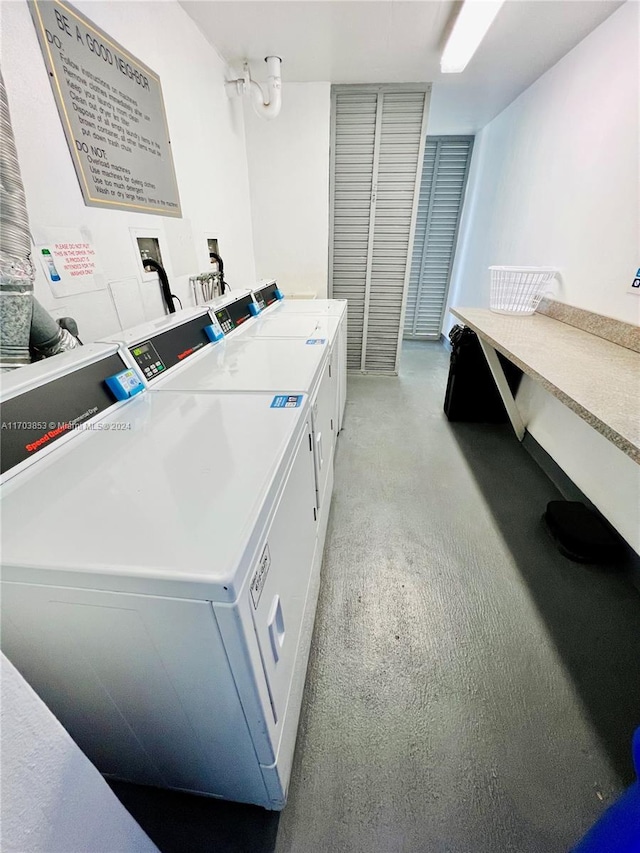 washroom with washer and dryer and light colored carpet