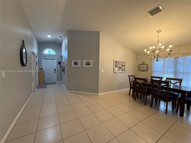 dining space with plenty of natural light, light tile patterned floors, and lofted ceiling