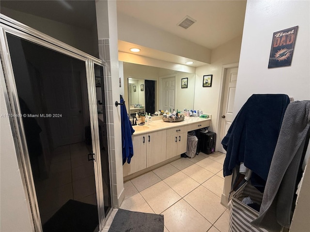 bathroom featuring tile patterned floors, vanity, and an enclosed shower