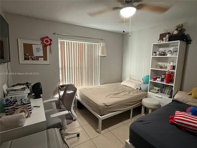 bedroom with ceiling fan and light tile patterned floors