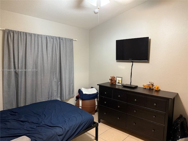 tiled bedroom featuring ceiling fan