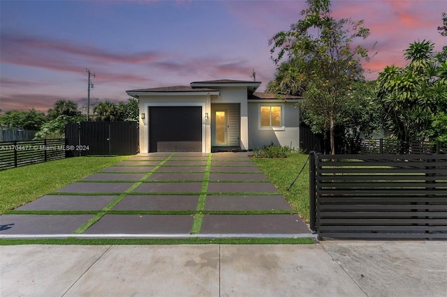 view of front of home featuring a yard and a garage