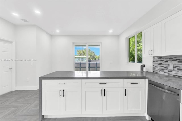 kitchen with dishwasher, kitchen peninsula, and white cabinetry