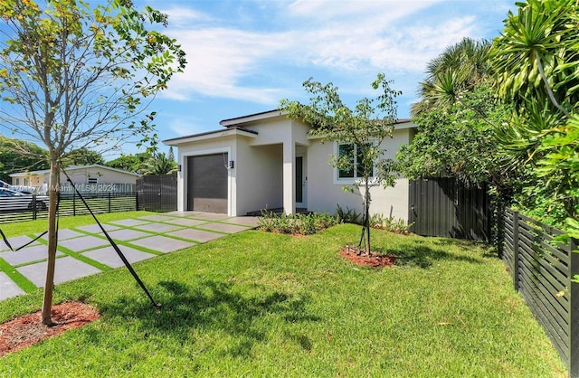 view of front facade with a front yard and a garage