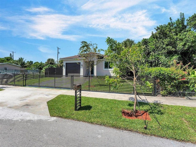 view of front of property featuring a front yard and a garage