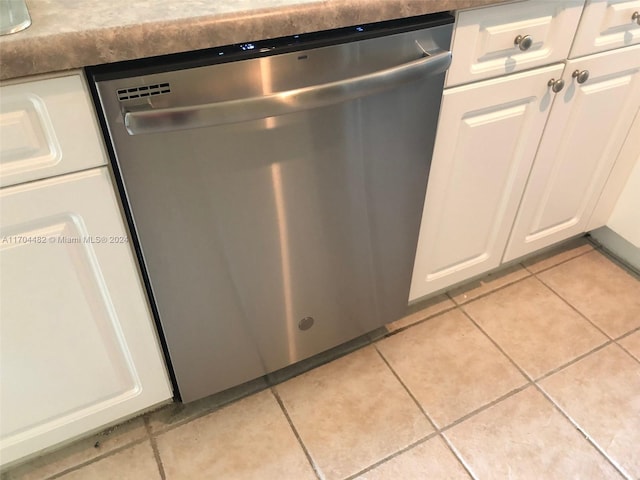 interior details with white cabinets and stainless steel dishwasher