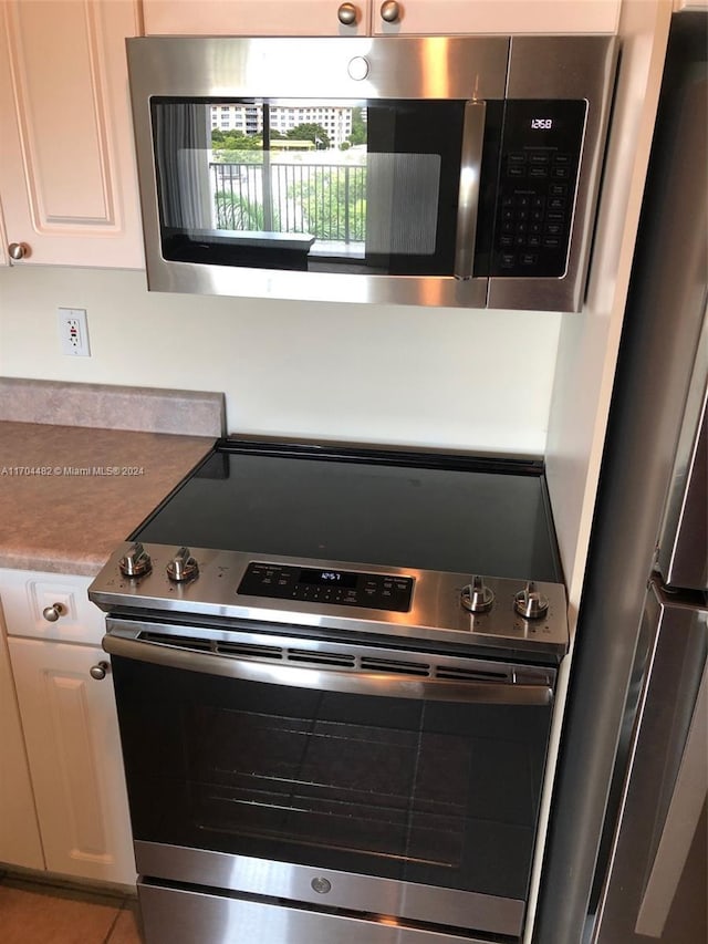 kitchen featuring white cabinets and appliances with stainless steel finishes