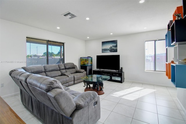 living room with light tile patterned floors and a healthy amount of sunlight