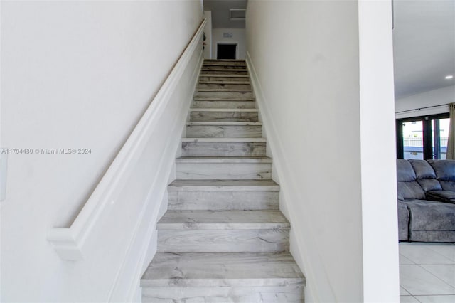 stairway with tile patterned flooring