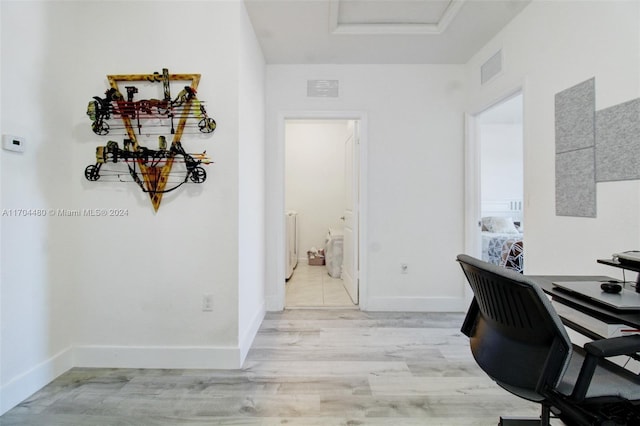 home office with light hardwood / wood-style floors