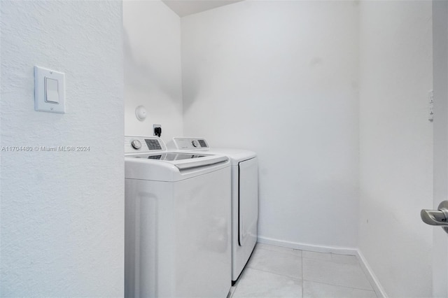 laundry area featuring independent washer and dryer and light tile patterned flooring