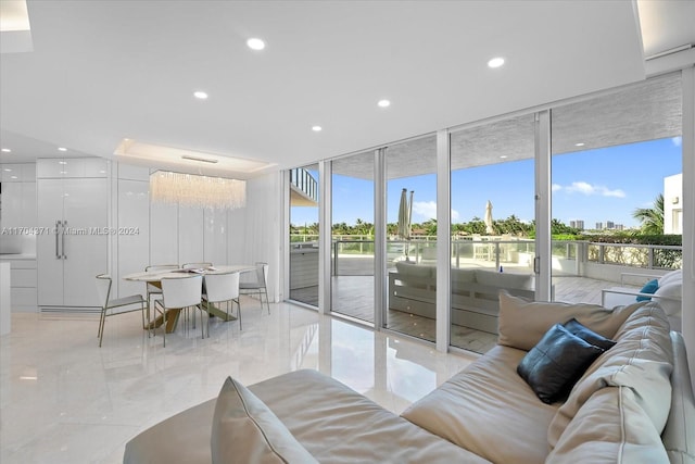 living room with a chandelier and floor to ceiling windows