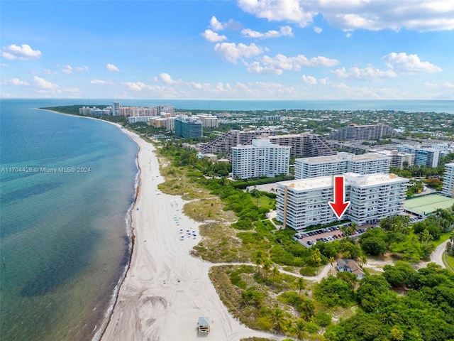 bird's eye view featuring a water view and a beach view