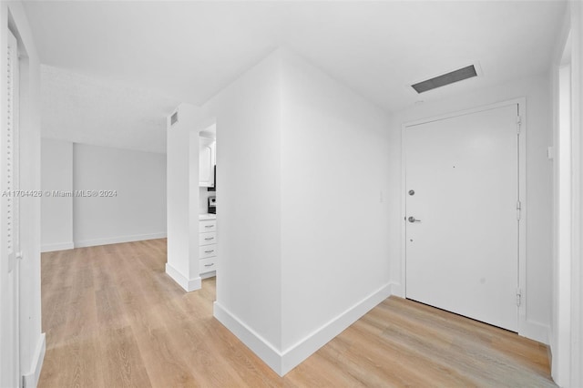 hallway with light wood-type flooring