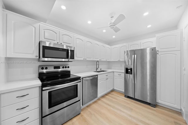 kitchen featuring white cabinets, light hardwood / wood-style floors, sink, and stainless steel appliances