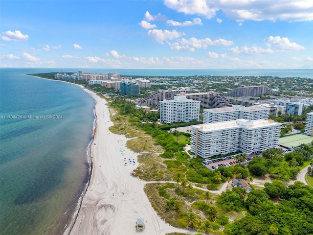 birds eye view of property with a beach view and a water view