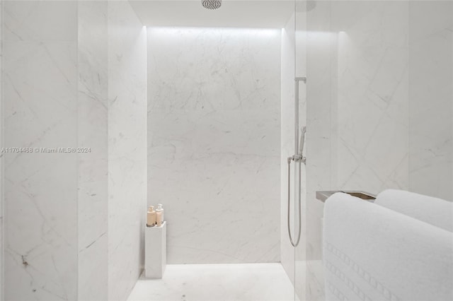 bathroom with tiled shower