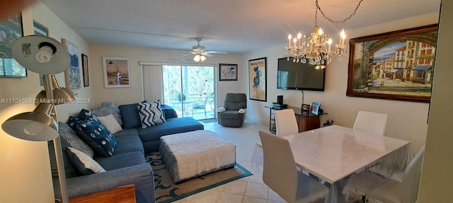 living room with ceiling fan with notable chandelier, light tile patterned floors, and a textured ceiling