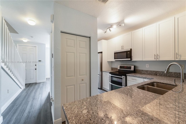 kitchen featuring light stone countertops, sink, white cabinets, and stainless steel appliances