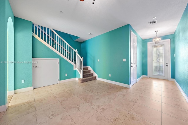 foyer entrance with an inviting chandelier