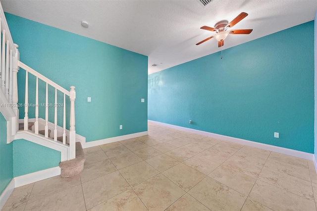 spare room with a textured ceiling and ceiling fan