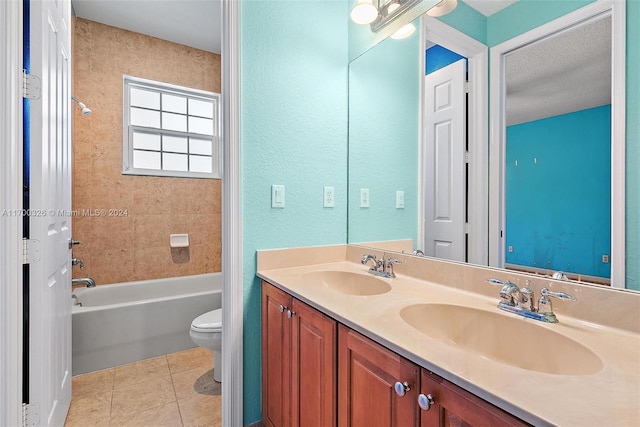 full bathroom featuring a textured ceiling, vanity, tile patterned flooring, toilet, and tiled shower / bath