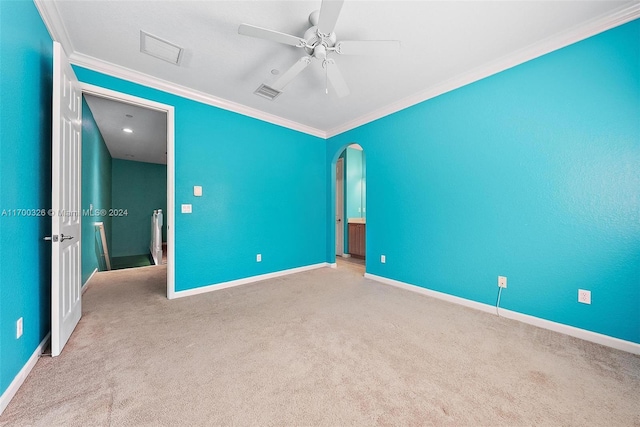 unfurnished bedroom featuring light colored carpet, ceiling fan, and crown molding