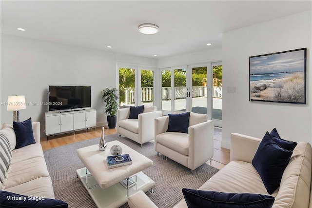 living room with light hardwood / wood-style flooring and french doors