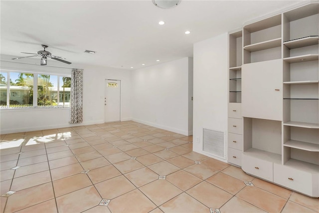 spare room featuring ceiling fan and light tile patterned floors