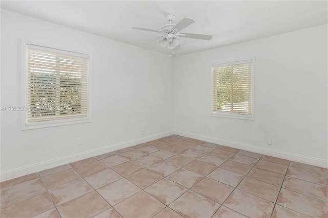 tiled empty room with ceiling fan