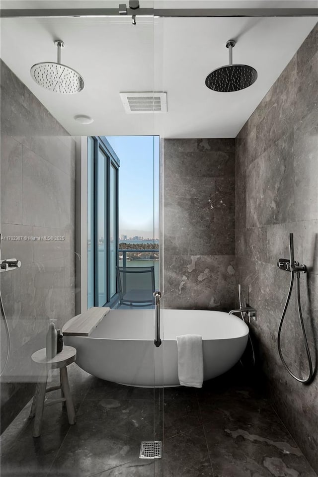 bathroom featuring expansive windows, separate shower and tub, and tile walls