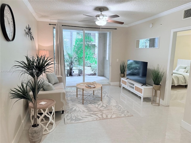 living room with a textured ceiling, ceiling fan, and ornamental molding