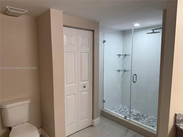 bathroom with vanity, an enclosed shower, and toilet