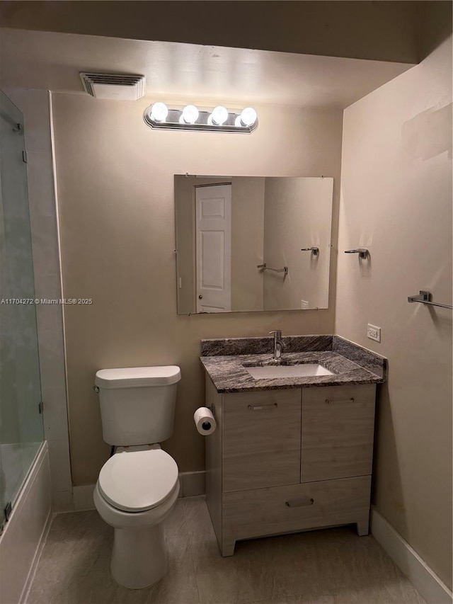 full bathroom with vanity, toilet, and bath / shower combo with glass door