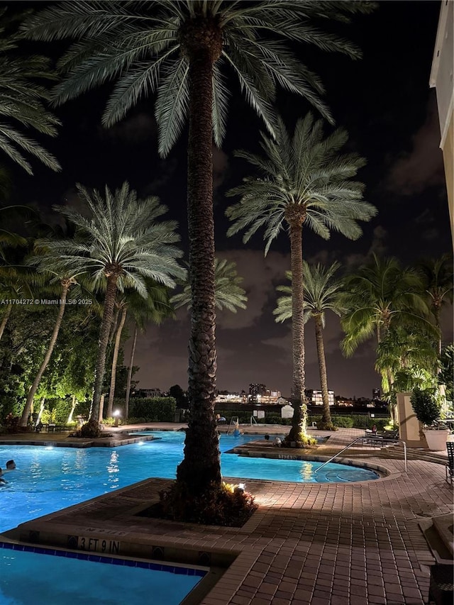 view of pool at night