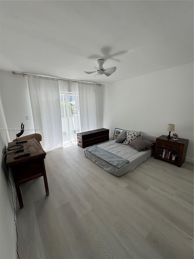 bedroom featuring access to exterior, light hardwood / wood-style flooring, and ceiling fan