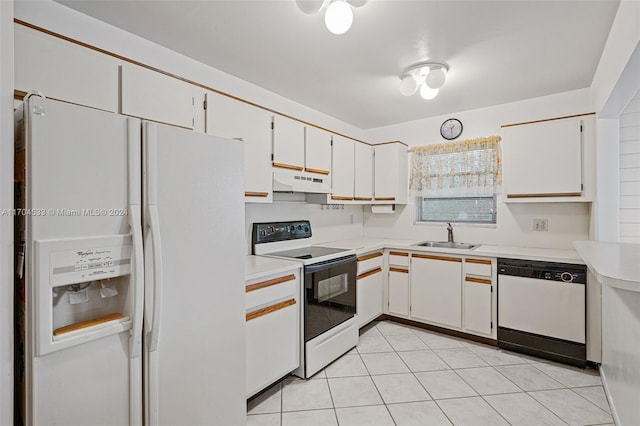 kitchen featuring white appliances, white cabinets, sink, light tile patterned floors, and kitchen peninsula