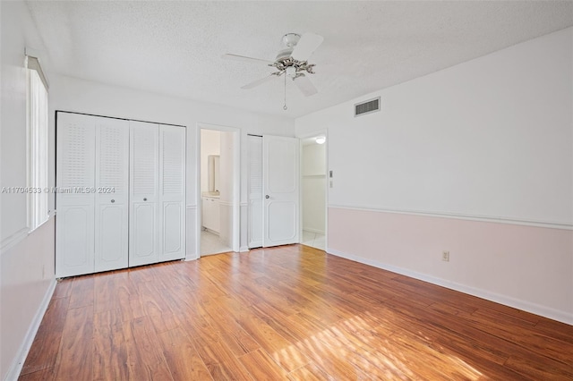 corridor with light tile patterned floors and a textured ceiling