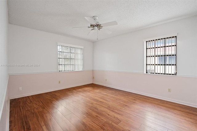 carpeted empty room featuring a textured ceiling and ceiling fan