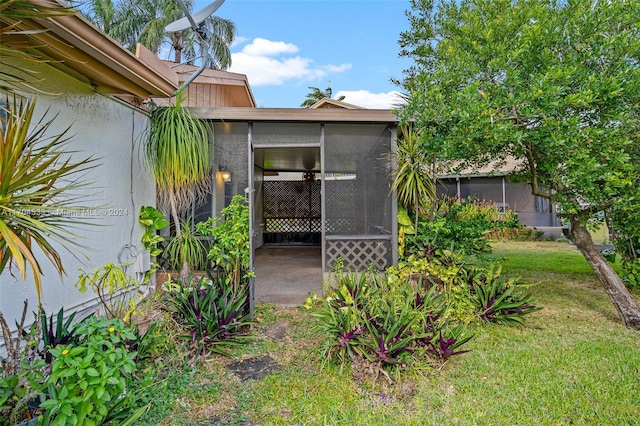 exterior space featuring a sunroom and a yard