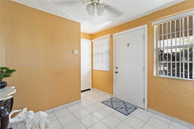 entryway featuring ceiling fan and light tile patterned flooring