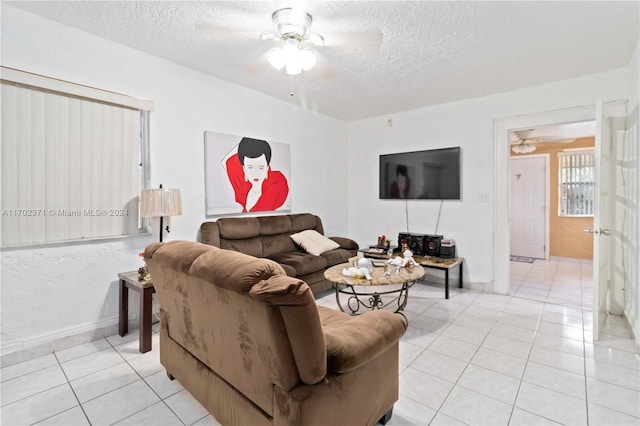 tiled living room featuring ceiling fan and a textured ceiling