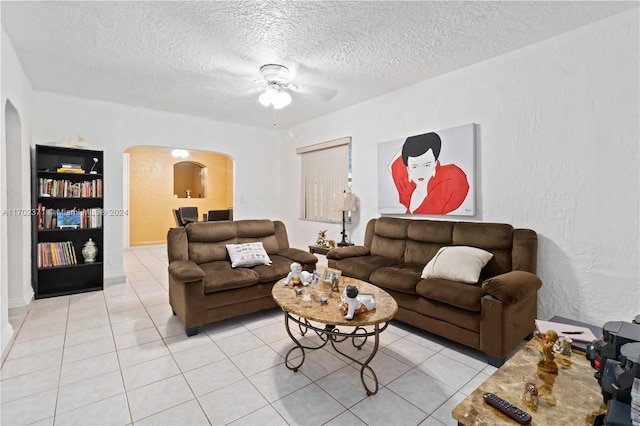 tiled living room featuring ceiling fan and a textured ceiling