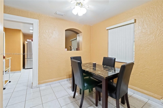 dining area with ceiling fan and light tile patterned flooring