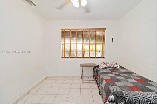 tiled bedroom with ceiling fan