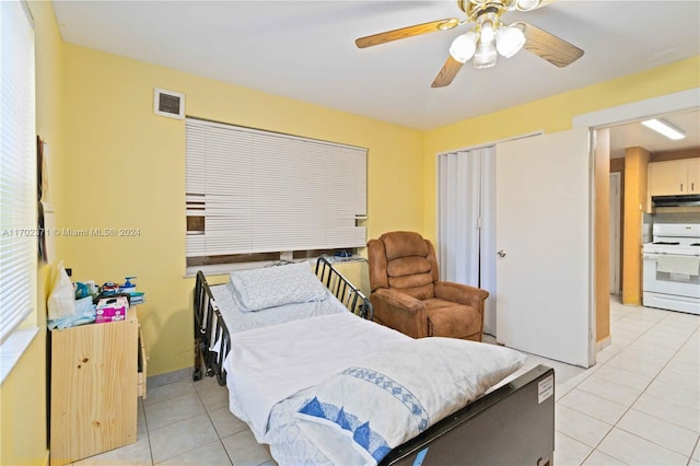 bedroom featuring a closet, ceiling fan, and light tile patterned flooring