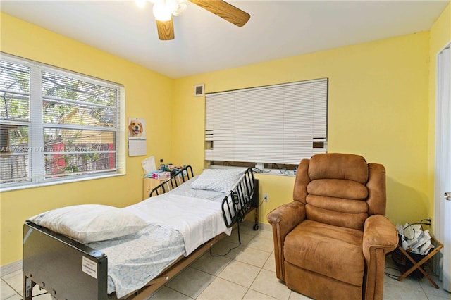 bedroom with ceiling fan and light tile patterned flooring