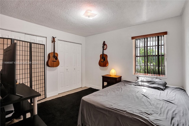 bedroom with a textured ceiling, hardwood / wood-style flooring, and a closet