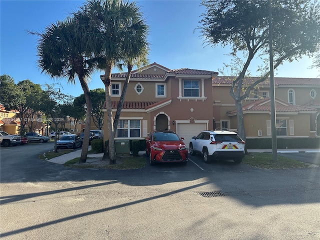 mediterranean / spanish-style home with a garage